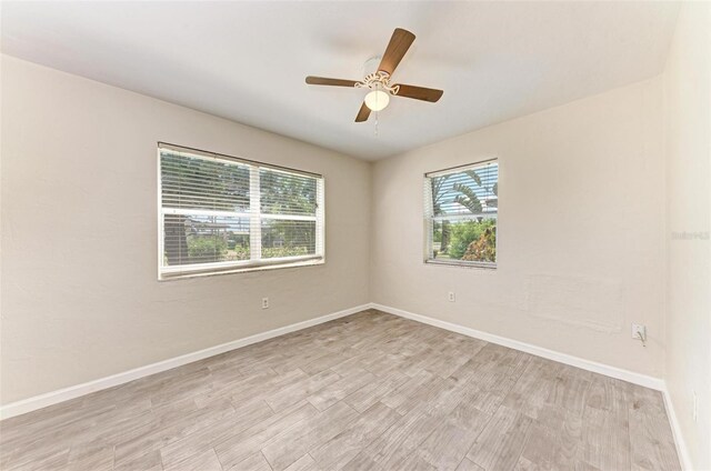 empty room with light hardwood / wood-style flooring and ceiling fan