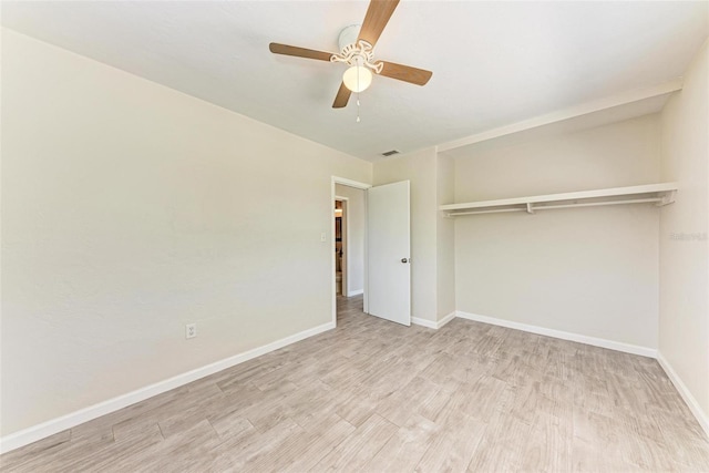 unfurnished bedroom with light hardwood / wood-style floors, a closet, and ceiling fan