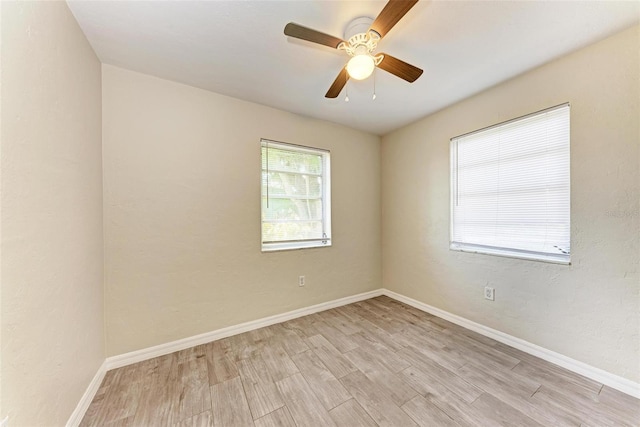 empty room featuring ceiling fan and light hardwood / wood-style flooring