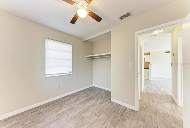 unfurnished bedroom with light hardwood / wood-style flooring, a closet, and ceiling fan