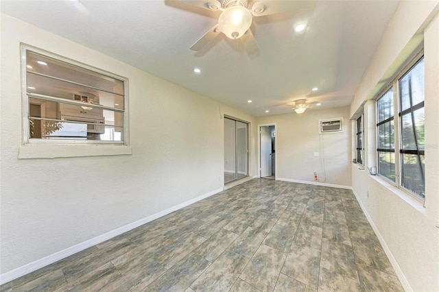 unfurnished room featuring a wall mounted AC, dark hardwood / wood-style floors, and ceiling fan