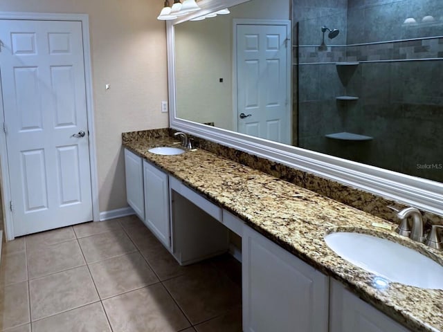 bathroom with tile patterned floors, vanity, and tiled shower