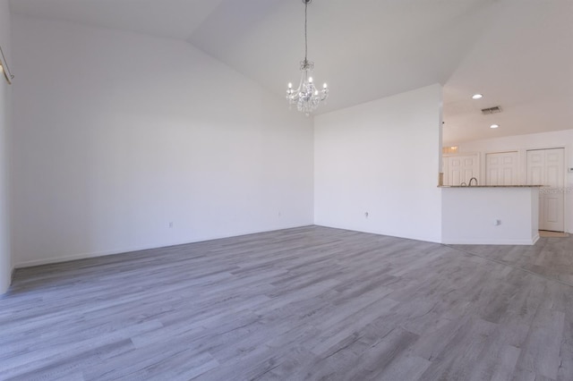 interior space featuring lofted ceiling, a chandelier, and light hardwood / wood-style floors