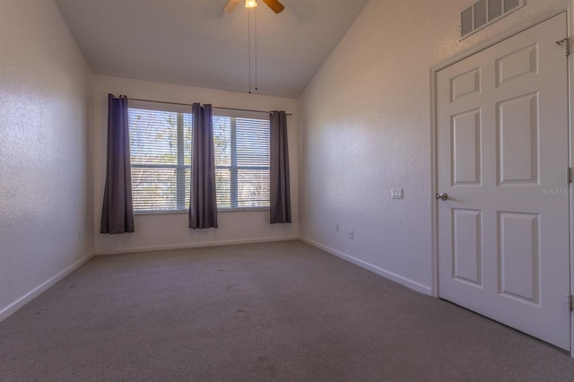 carpeted empty room featuring vaulted ceiling and ceiling fan