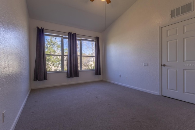 carpeted empty room featuring ceiling fan and lofted ceiling