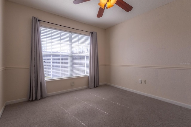 carpeted empty room featuring ceiling fan