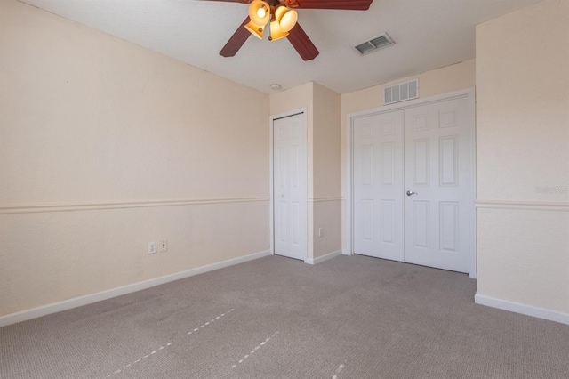 unfurnished bedroom featuring carpet floors, ceiling fan, and a closet