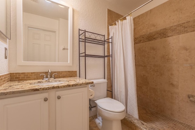 bathroom with vanity, a shower with shower curtain, backsplash, and toilet