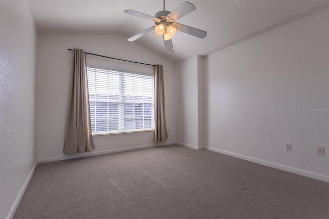 spare room featuring ceiling fan, lofted ceiling, and carpet flooring