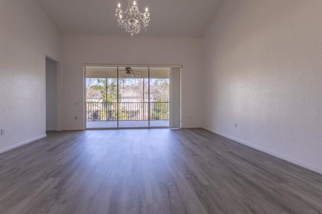 unfurnished room featuring dark hardwood / wood-style floors and a chandelier