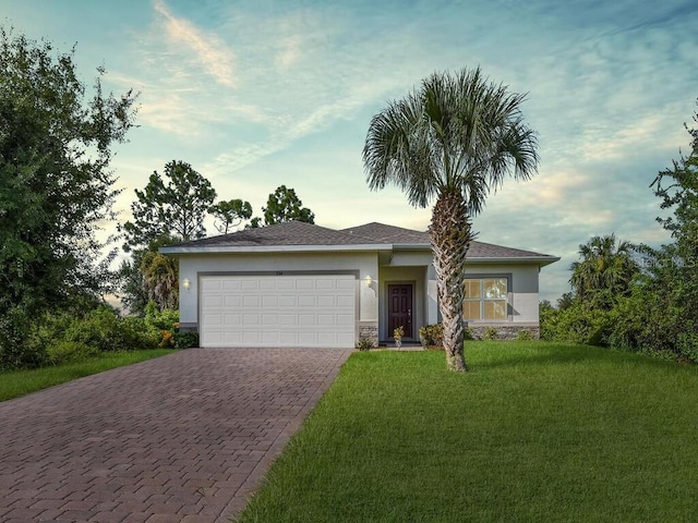 ranch-style house with a yard and a garage