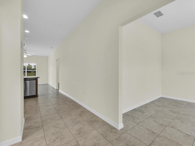 hall with light tile patterned floors