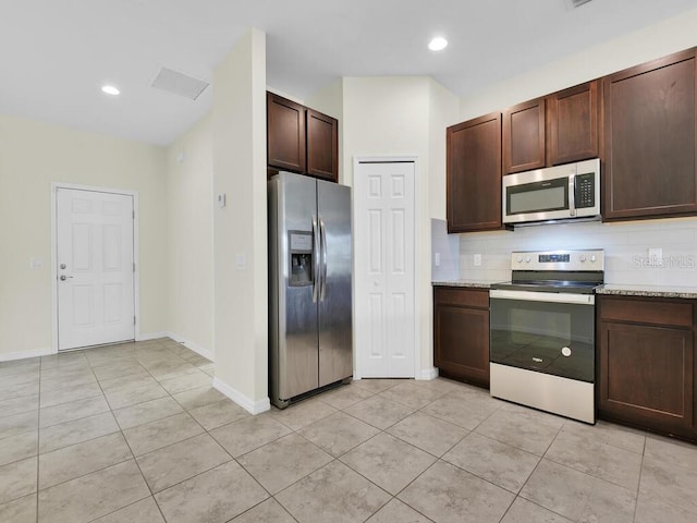 kitchen featuring dark brown cabinets, light tile patterned flooring, stainless steel appliances, and backsplash