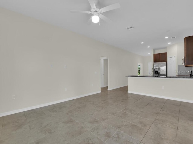 unfurnished living room with ceiling fan and light tile patterned floors