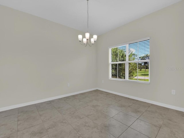 spare room with light tile patterned floors and a chandelier