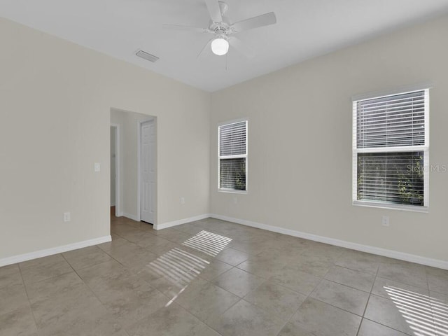 spare room featuring ceiling fan and light tile patterned flooring