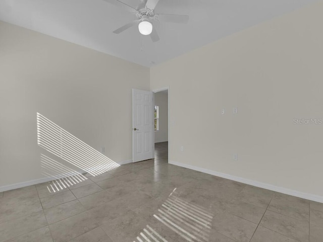 empty room featuring ceiling fan and light tile patterned floors