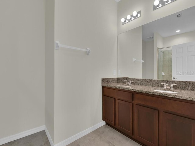 bathroom featuring vanity, tile patterned floors, and a shower with shower door