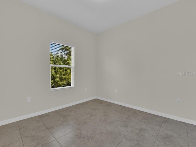 spare room featuring light tile patterned floors