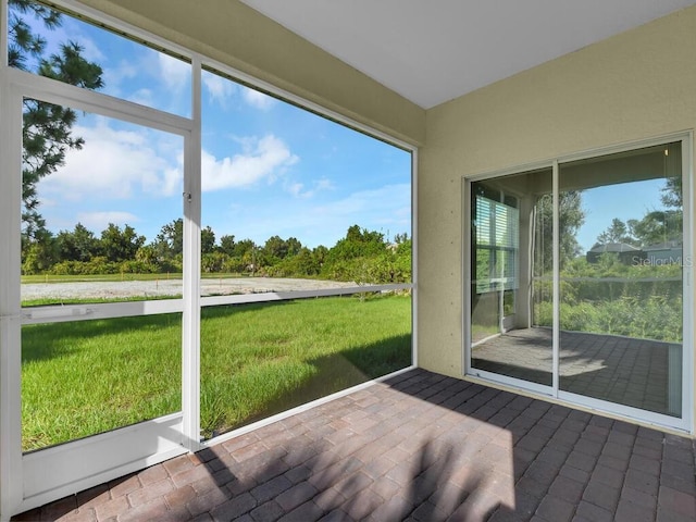 unfurnished sunroom with a water view