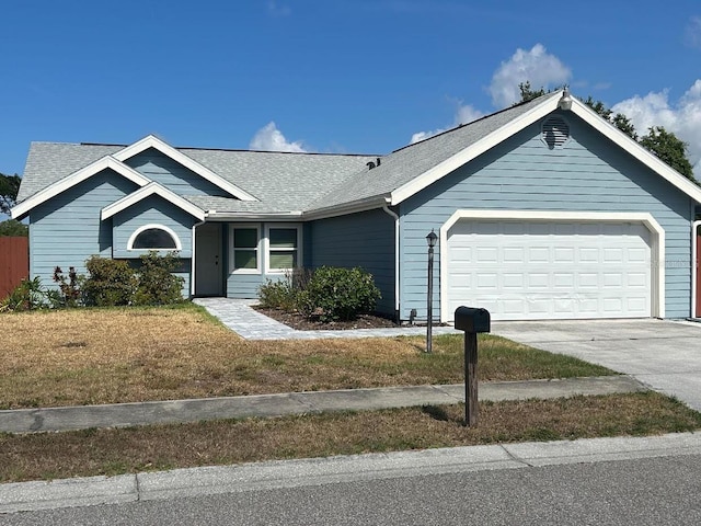 ranch-style home with a garage and a front yard