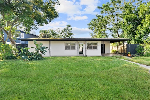 view of front of home with a front lawn and a carport