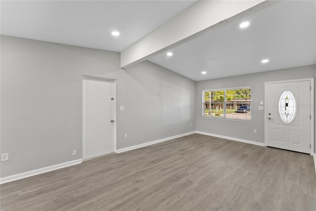 entryway featuring light hardwood / wood-style flooring and beam ceiling