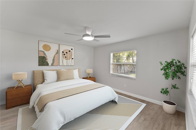 bedroom featuring light hardwood / wood-style floors and ceiling fan