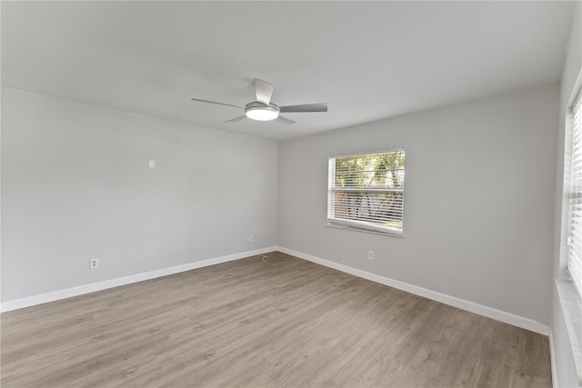 unfurnished room featuring light wood-type flooring and ceiling fan