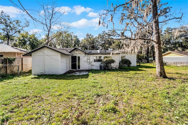 back of house with a lawn