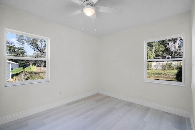 empty room with light hardwood / wood-style floors and ceiling fan