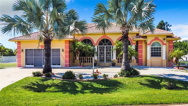 mediterranean / spanish home featuring a front yard