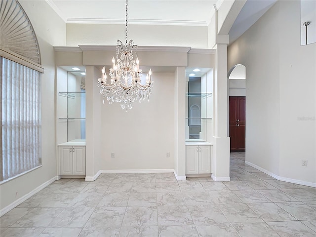 unfurnished dining area featuring crown molding, a chandelier, and a high ceiling