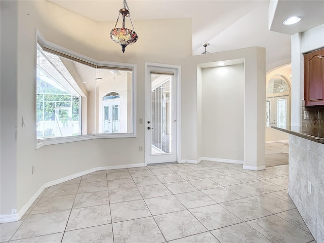 tiled foyer entrance with lofted ceiling