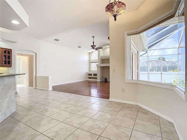 unfurnished living room featuring ceiling fan