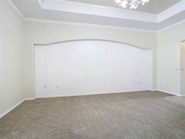 unfurnished room with ornamental molding, carpet, and a chandelier