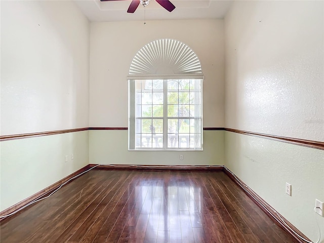 empty room featuring ceiling fan and dark wood-type flooring