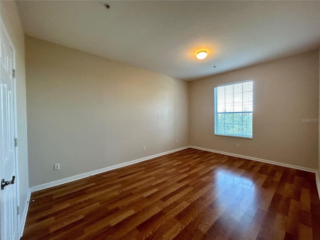 empty room with dark hardwood / wood-style floors