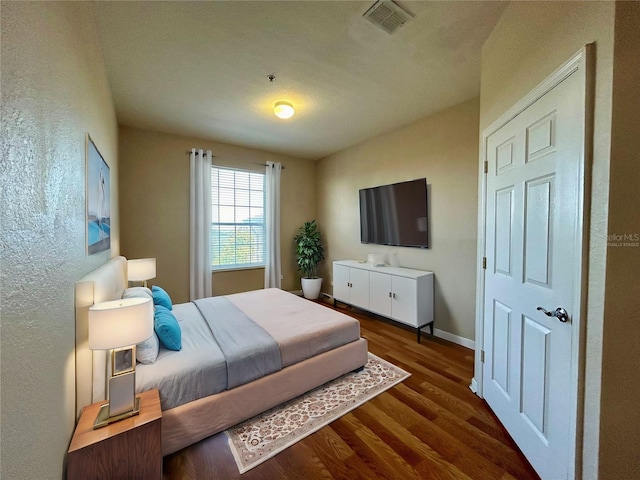 bedroom featuring dark wood-type flooring