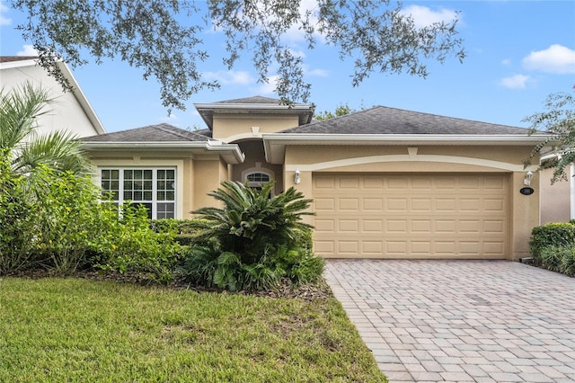 view of front facade with a front lawn and a garage