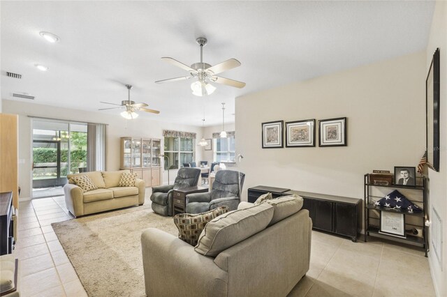 tiled living room with ceiling fan