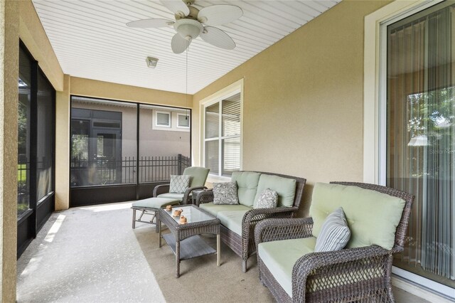 sunroom / solarium featuring wood ceiling and ceiling fan