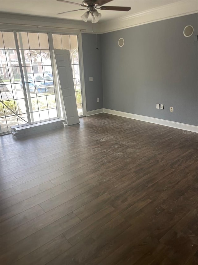 spare room with ornamental molding, ceiling fan, and dark hardwood / wood-style flooring