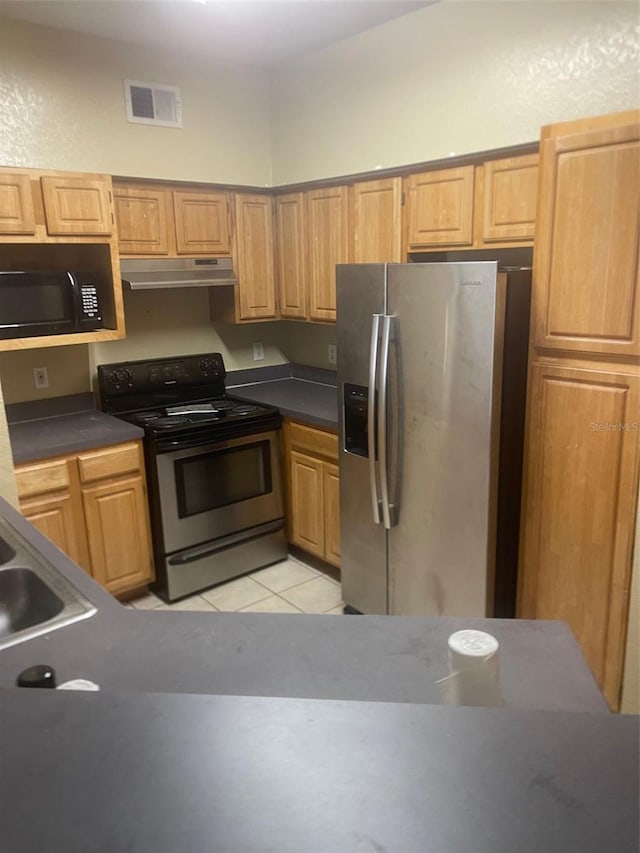 kitchen featuring sink, black appliances, and light tile patterned flooring