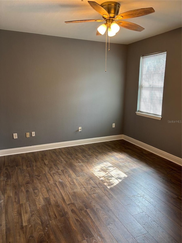 empty room featuring dark wood-type flooring and ceiling fan