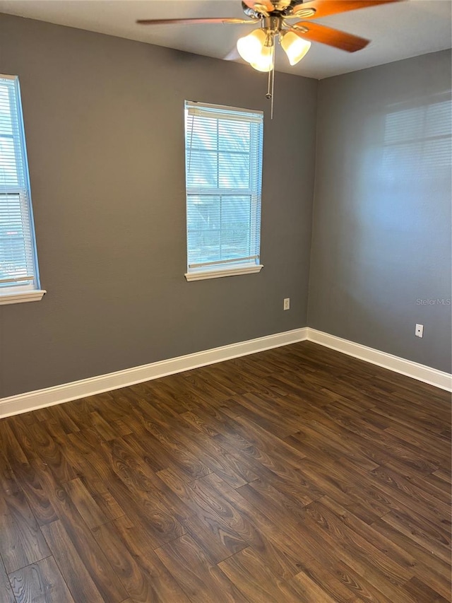 spare room featuring ceiling fan and dark hardwood / wood-style flooring