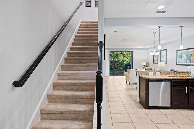 stairs with sink and tile patterned floors