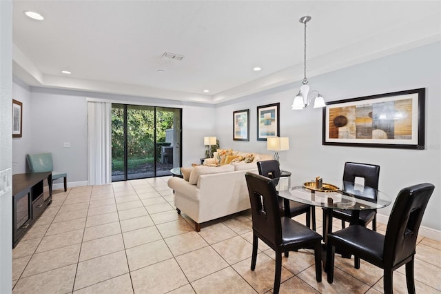 8091 Brooksville Dr, Davenport, FL 33896 - dining room featuring light tile patterned flooring, a raised ceiling, a chandelier, recessed lighting, and baseboards
