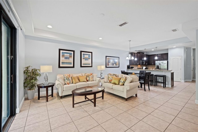 living room featuring light tile patterned floors and a chandelier