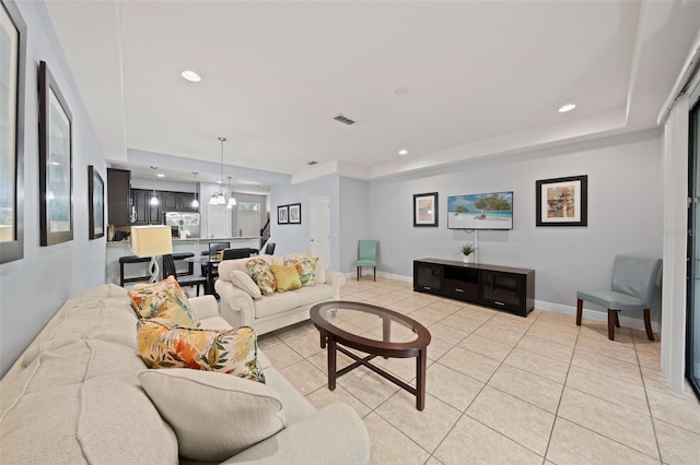 living room with a healthy amount of sunlight, a chandelier, and light tile patterned floors